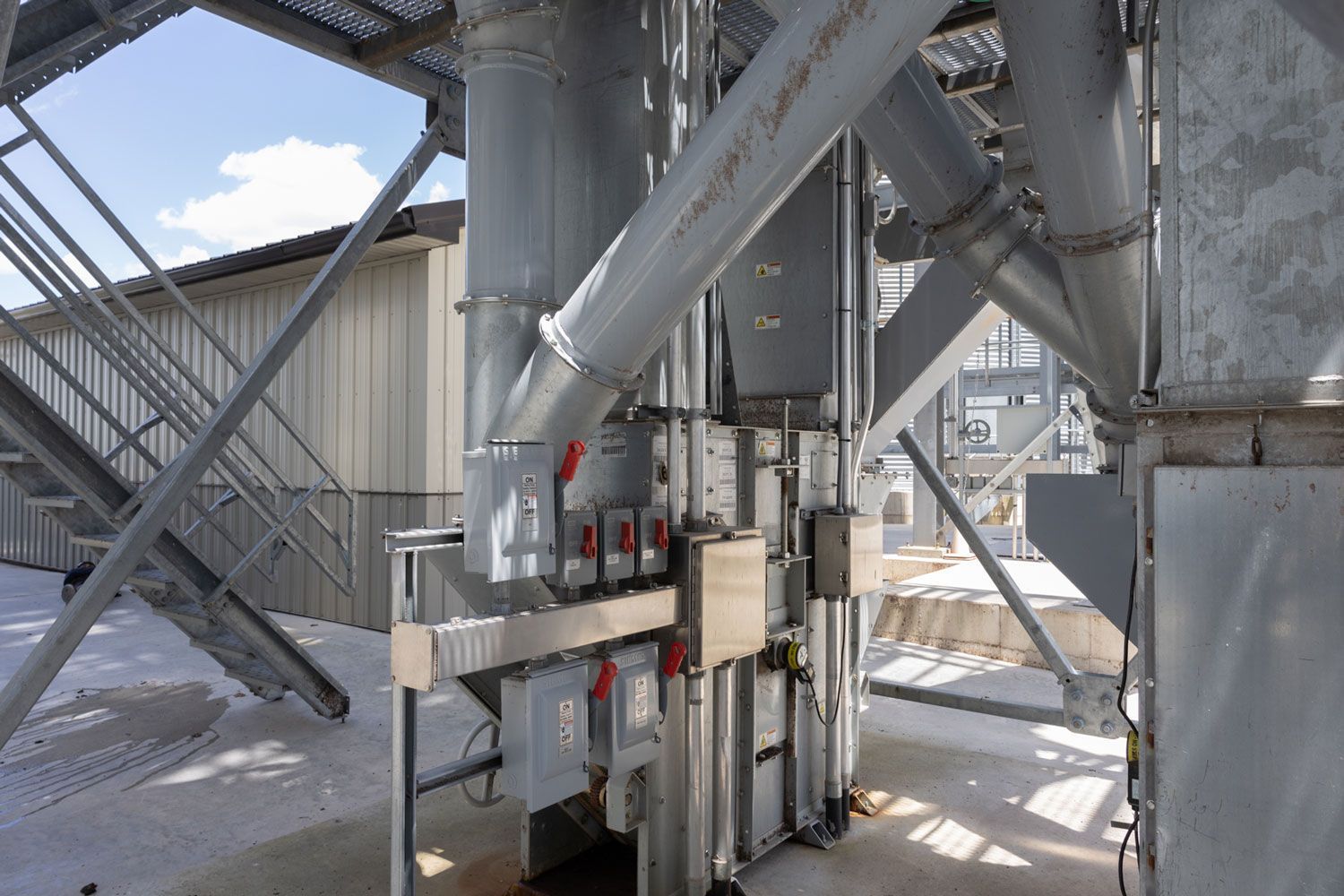 A large metal structure with stairs leading up to it