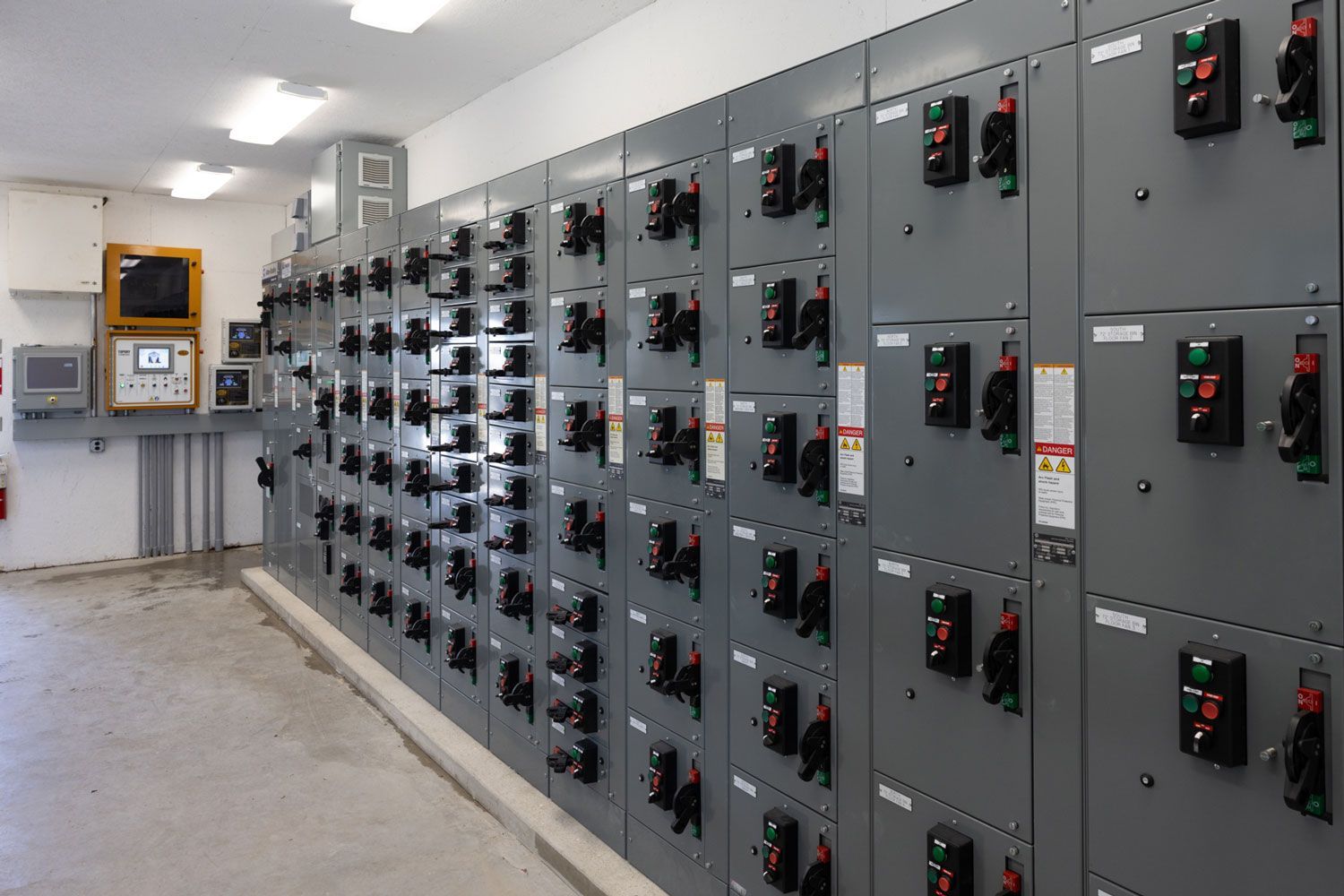 A room with a lot of electrical boxes and a sign that says g2