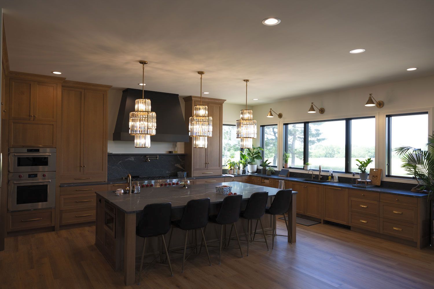 A large kitchen with a large island and lots of windows.