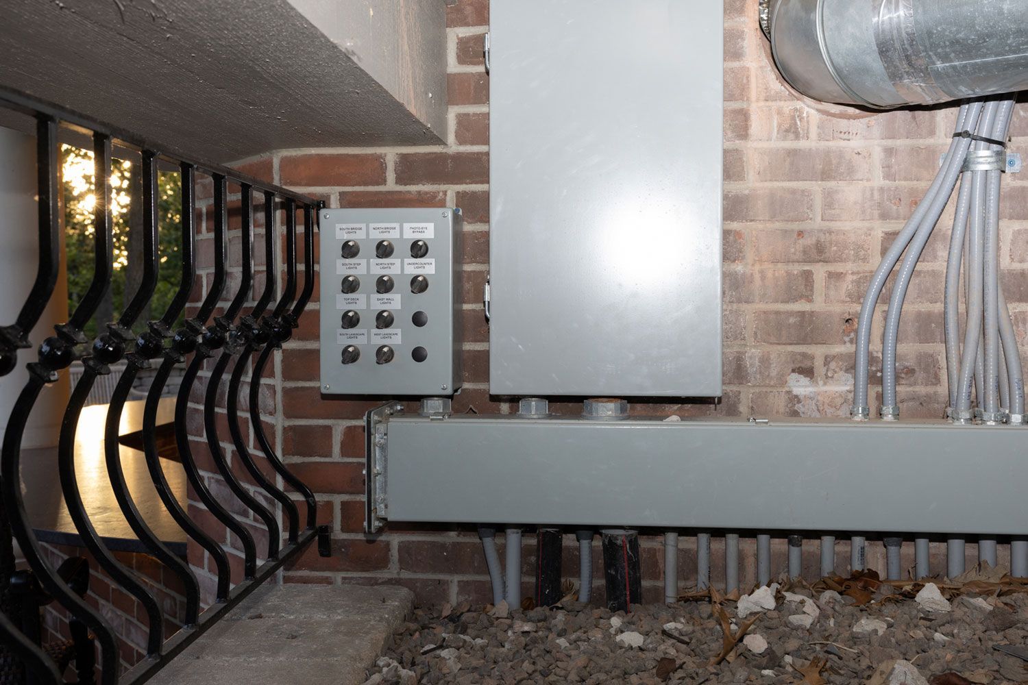 A brick wall with a box on it that says ' electrical ' on it