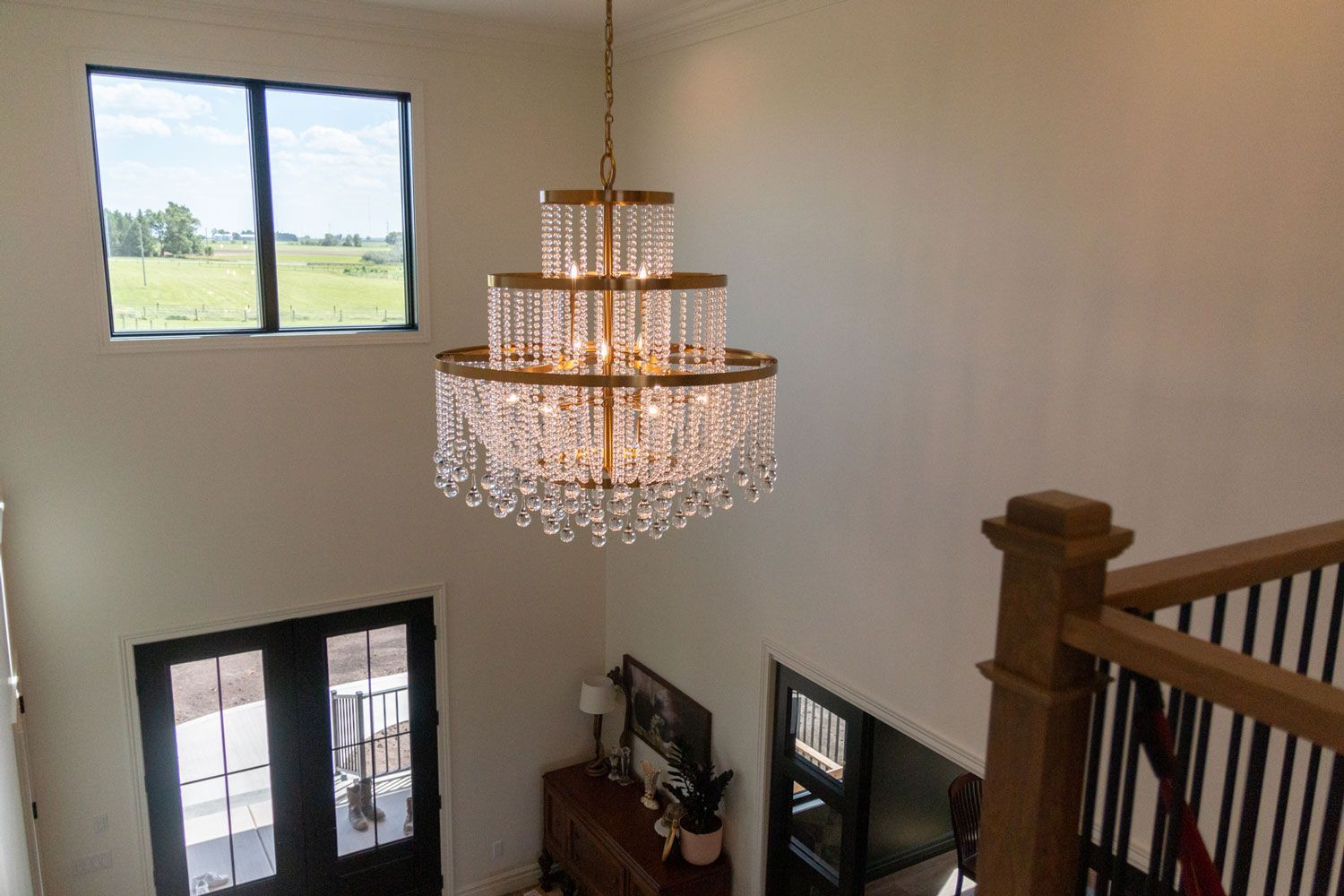 A large chandelier is hanging from the ceiling of a house.