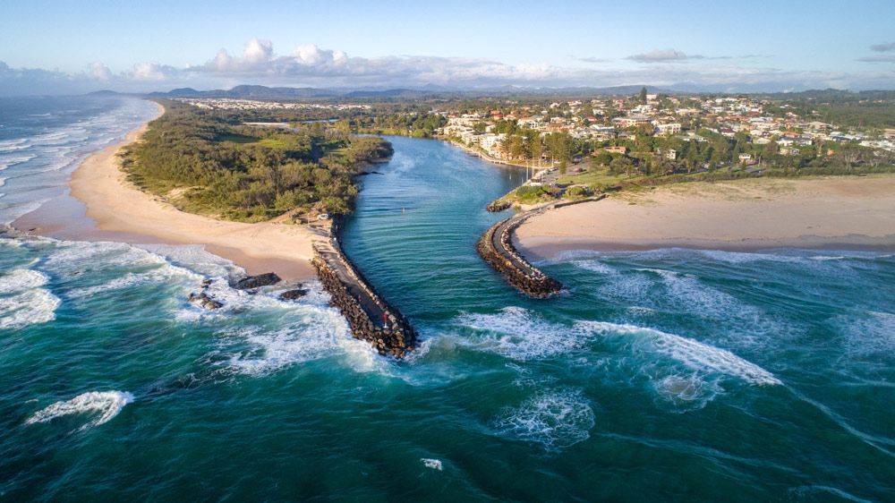 An Aerial View Of A River Flowing Into The Ocean Next To A Beach — Mr Steam Clean Tweed Coast In Kingscliff, NSW