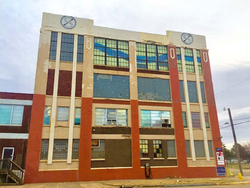 Multi-story brick building with large windows and clock faces on the roofline, Salina, Kansas