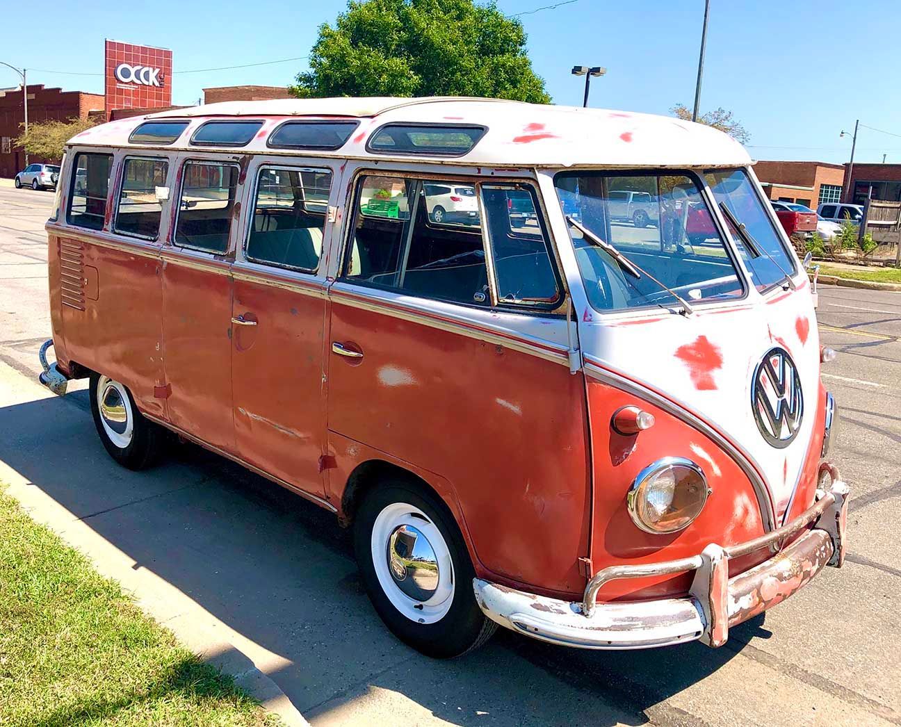 Vintage red-and-white Volkswagen van parked outdoors on a sunny street, VW-bus, 23-window Samba, Salina, Kansas