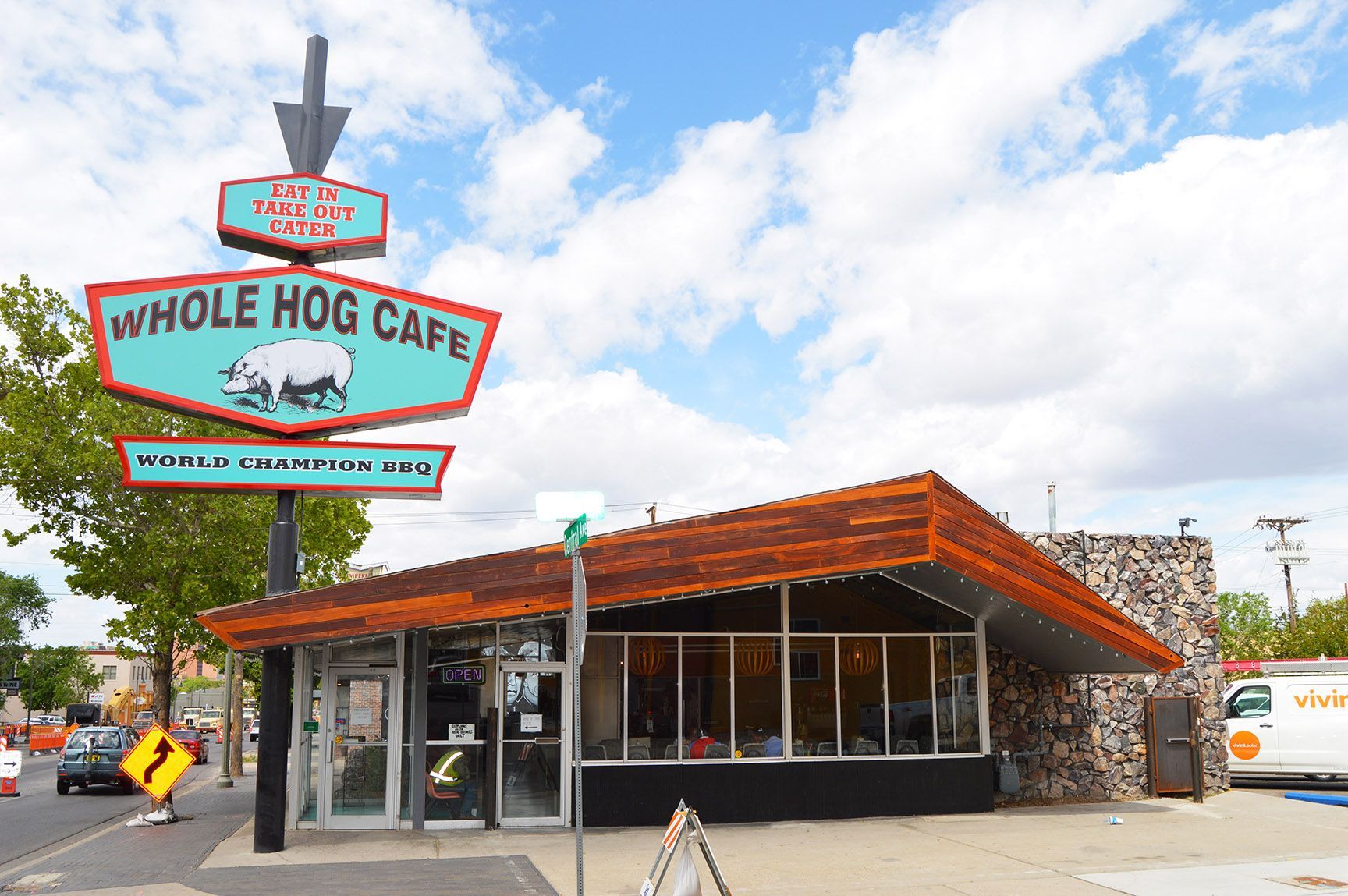 Whole Hog Cafe restaurant exterior with large roadside sign and orange-roofed building