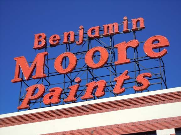 Benjamin Moore Paints sign on a building against a blue sky