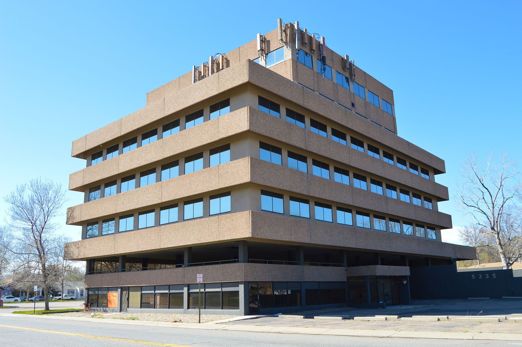 Brown office building with rows of windows on a clear day