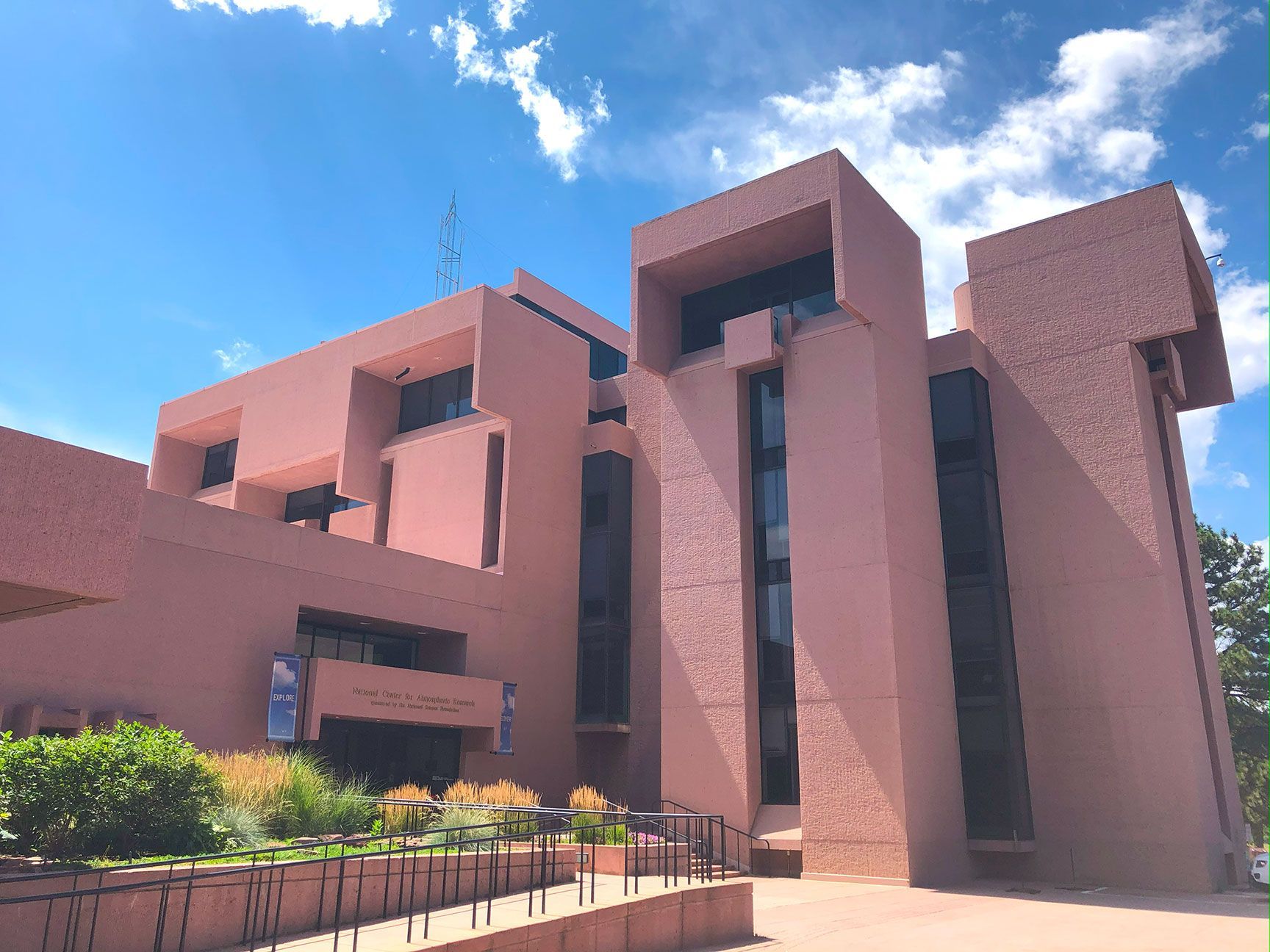 Brutalist Architecture with geometric towers against a bright blue sky, NCAR, Boulder, Colorado
