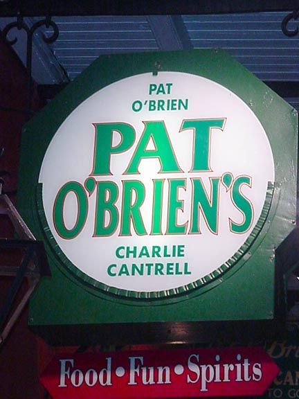 Pat O'Brien's round green and white sign with red text and “Food • Fun • Spirits” below