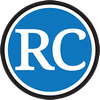 Blue circular logo with white “RC” letters and a black-and-white border