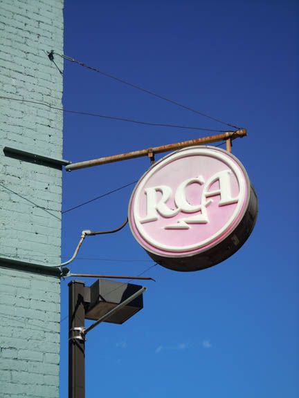 RCA sign on a building wall against a blue sky