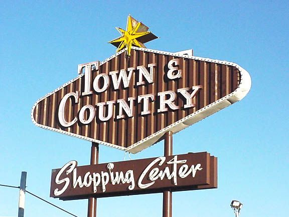 Town & Country Shopping Center sign with a star on top against a blue sky