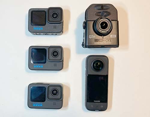 Five action cameras arranged in two columns on a white background.