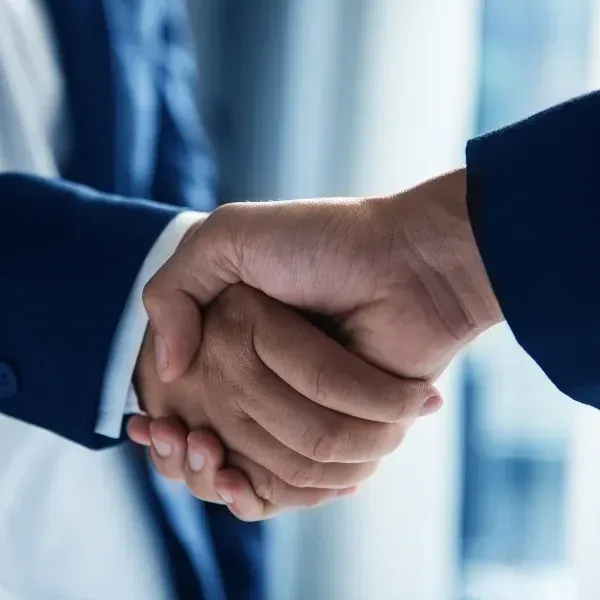 An image representing two hands shaking in agreement.