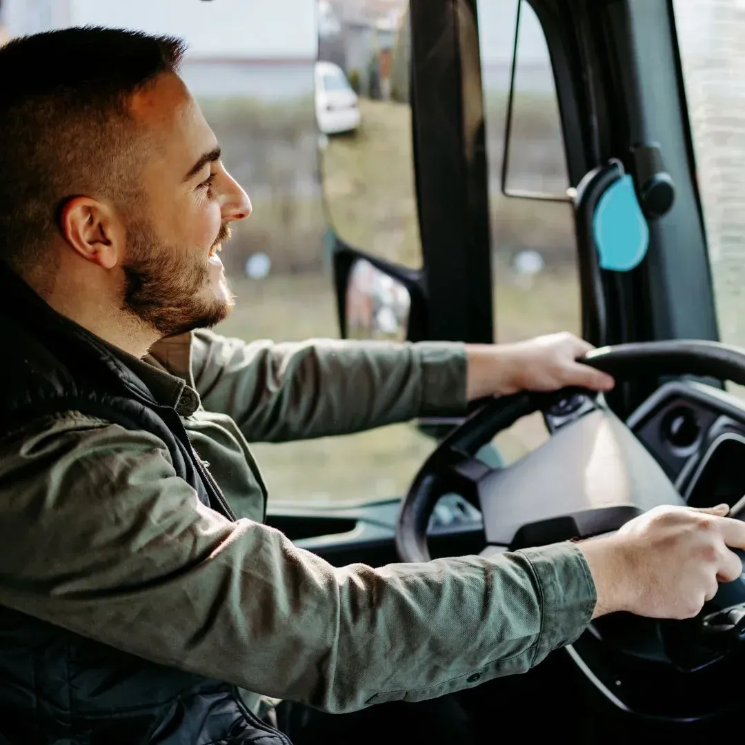 An image showing a truck driver behind the wheel.