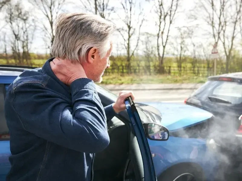 Image of a driver dealing with the aftermath of a vehicle accident in Georgia.