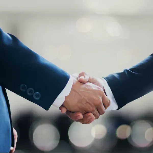 An image of two hands shaking in agreement.