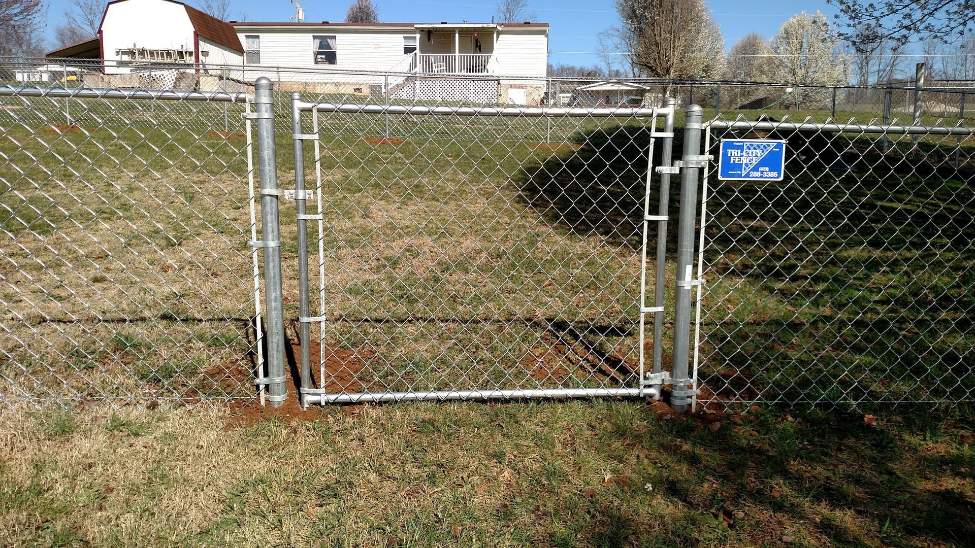 A chain link fence along the side of a road A chain link fence along the side of a road