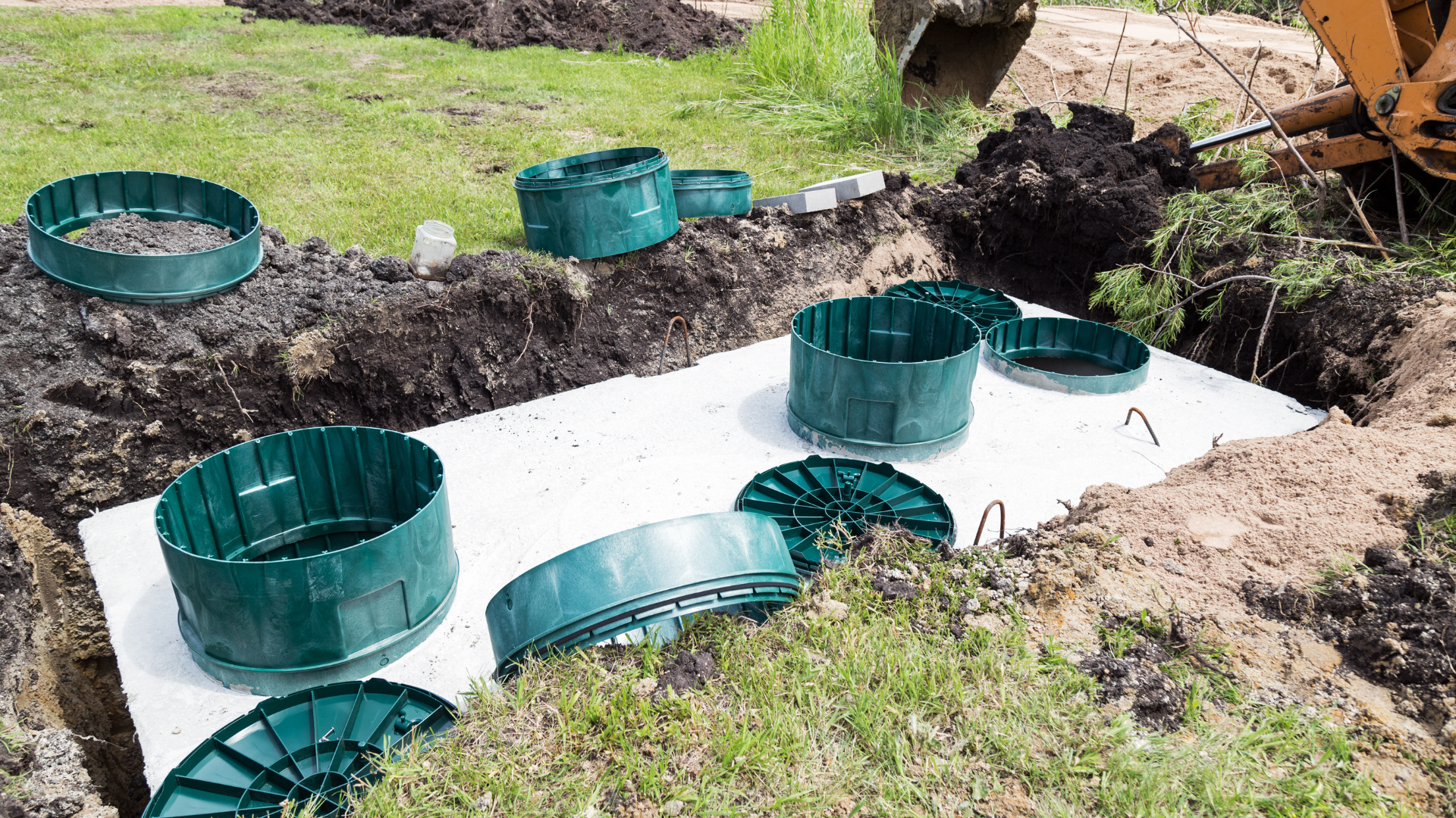 A septic tank is being built in a hole in the ground.