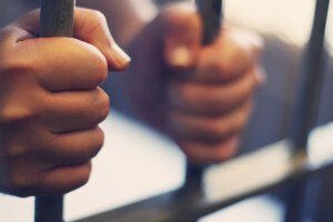 person behind prison bars