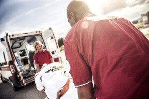 paramedics load patient into ambulance
