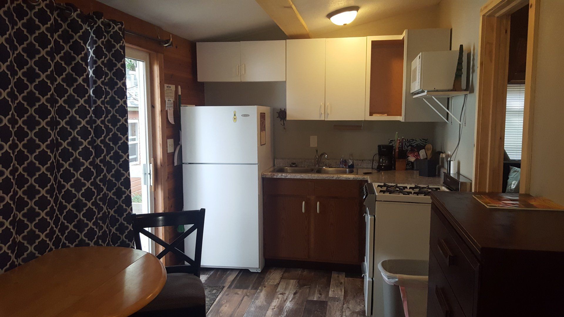 A kitchen with a table and chairs and a refrigerator