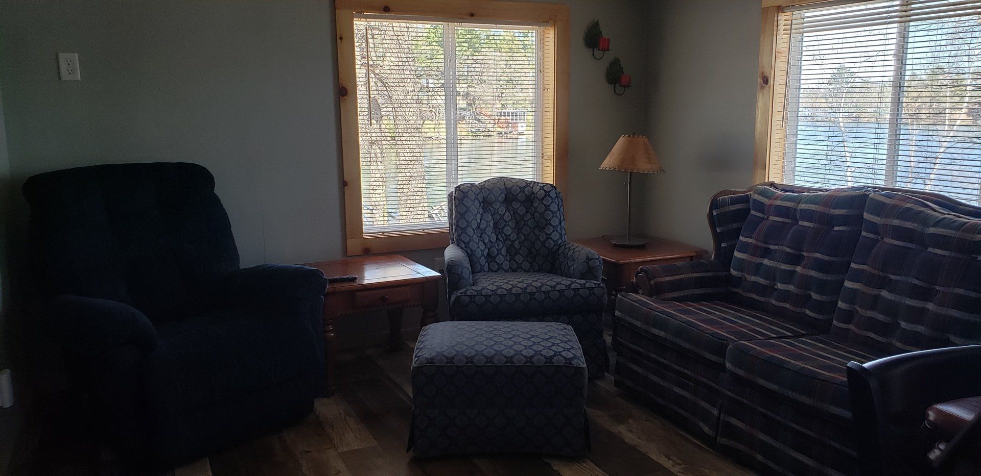 A living room with a couch , chair and ottoman