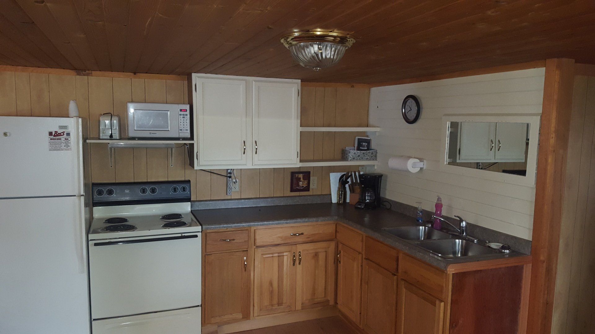 A kitchen with a stove a refrigerator and a sink