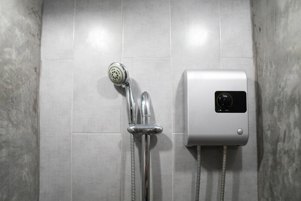 Professional plumber checking water heating system for gas leaks.