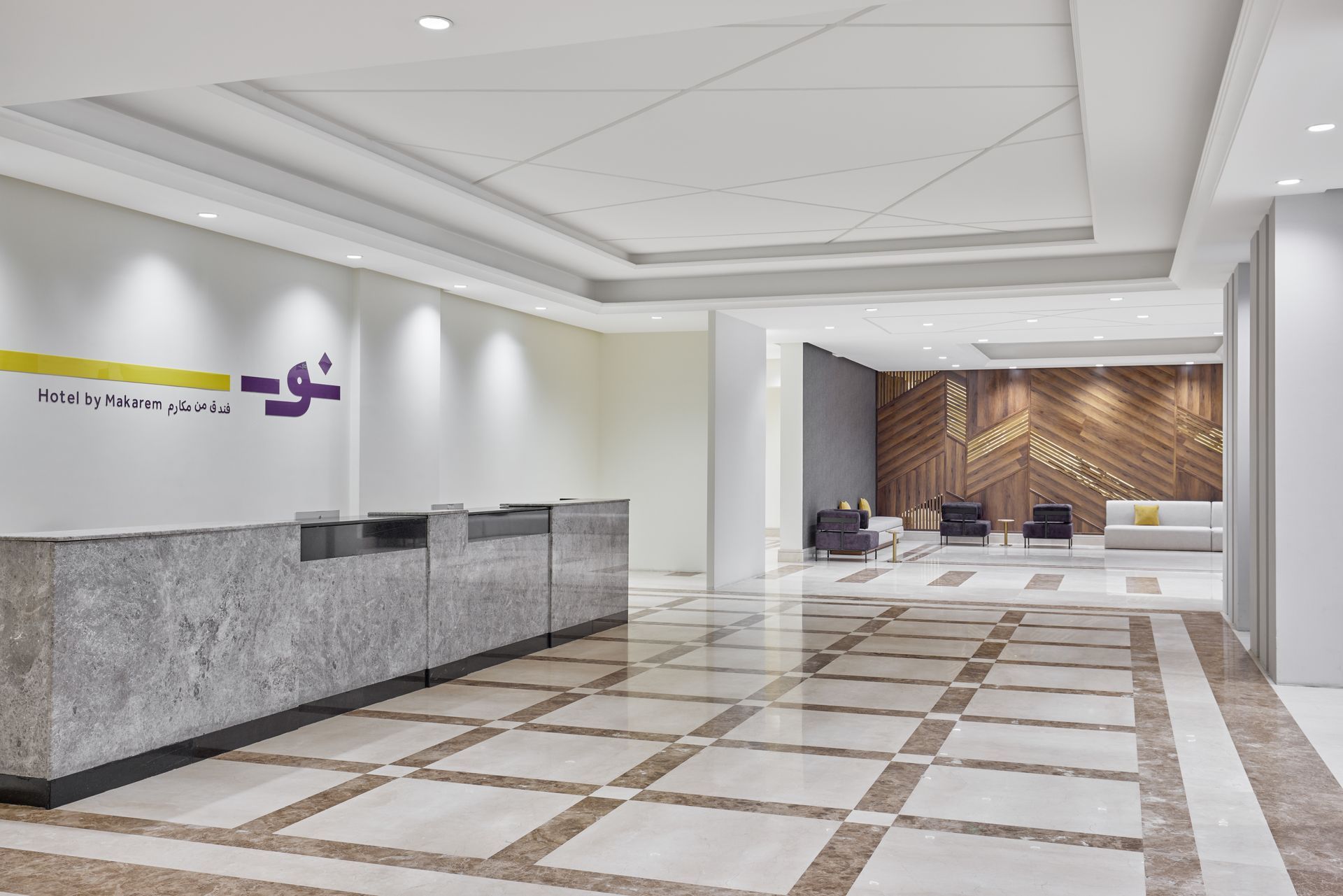 Modern lobby with marble floor, reception desk, and geometric ceiling lights