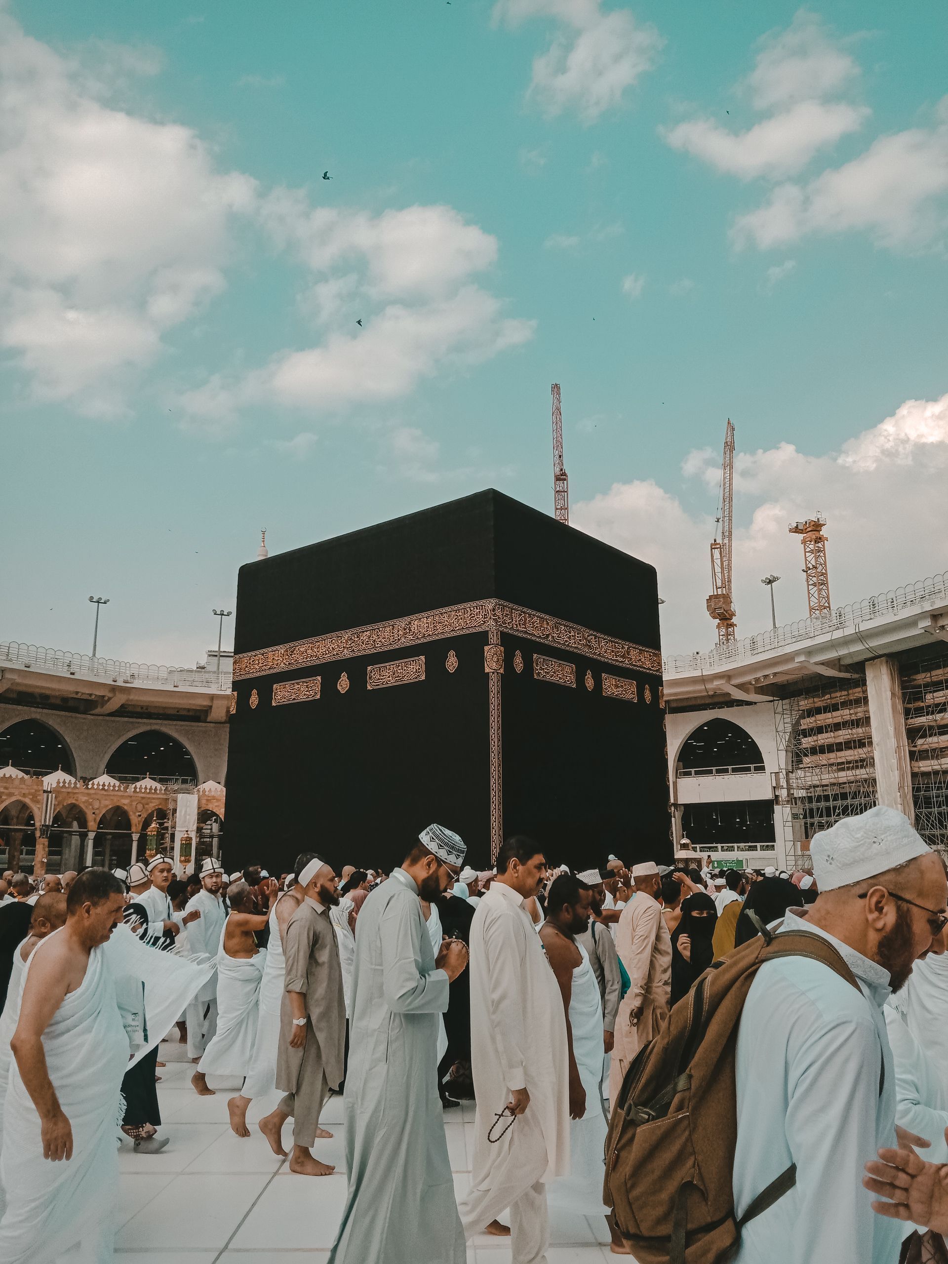 Pilgrims in white garments circumambulate the Kaaba at the Grand Mosque in Mecca.