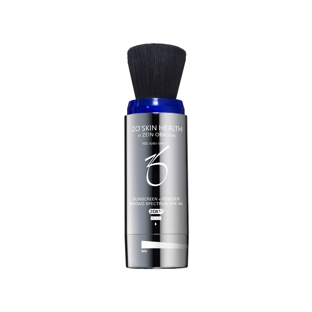 A cylindrical, silver ZO Skin Health sunscreen brush with a dark brush head.