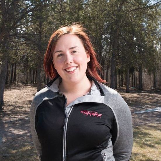women with red hair looking at camera A woman wearing a patagonia jacket smiles for the camera