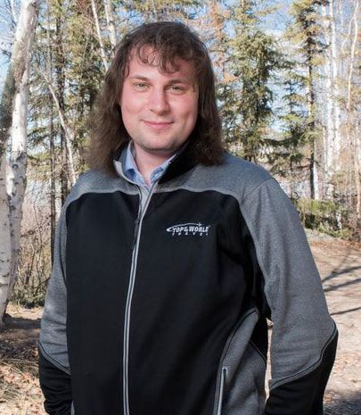 man with long hair looking at camera A man with long hair is wearing a columbia jacket