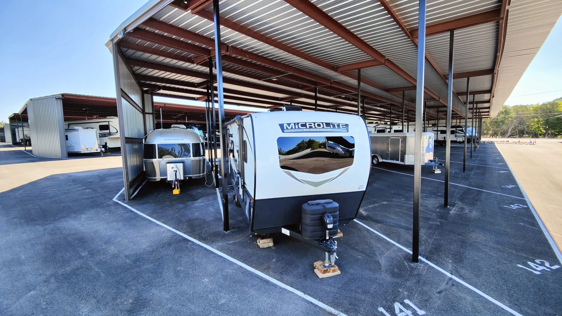 RV storage facility: Covered parking spaces with several recreational vehicles parked underneath.
