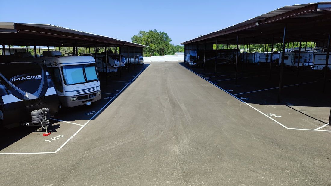 RV storage facility with covered parking bays and paved driveways.