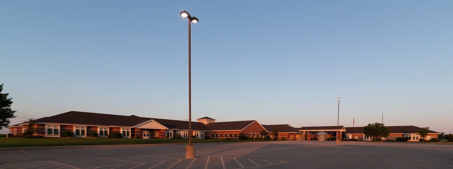 A parking lot with a large building in the background