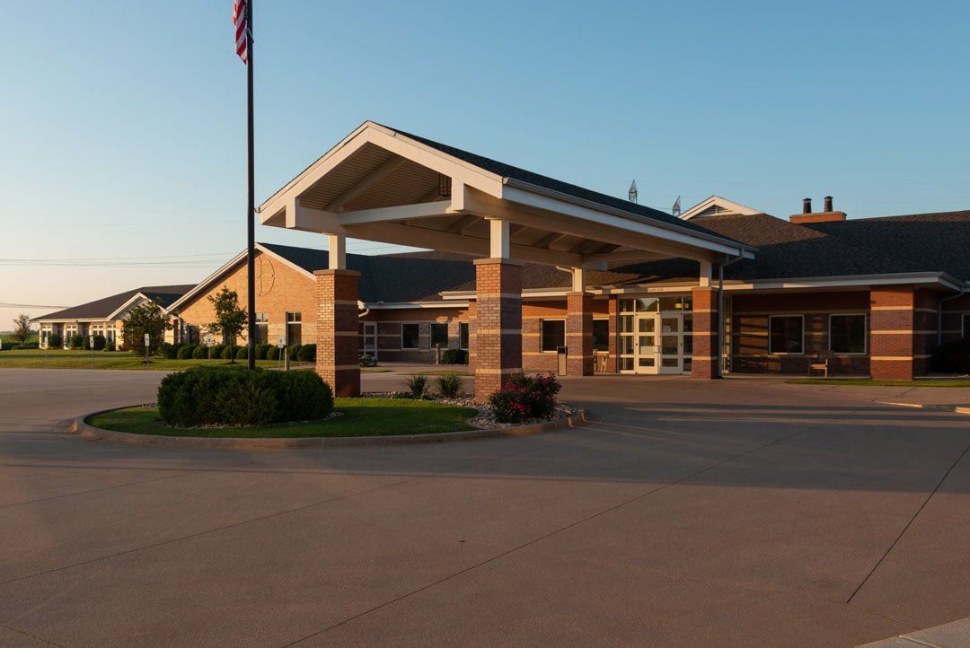 A large brick building with a flag in front of it