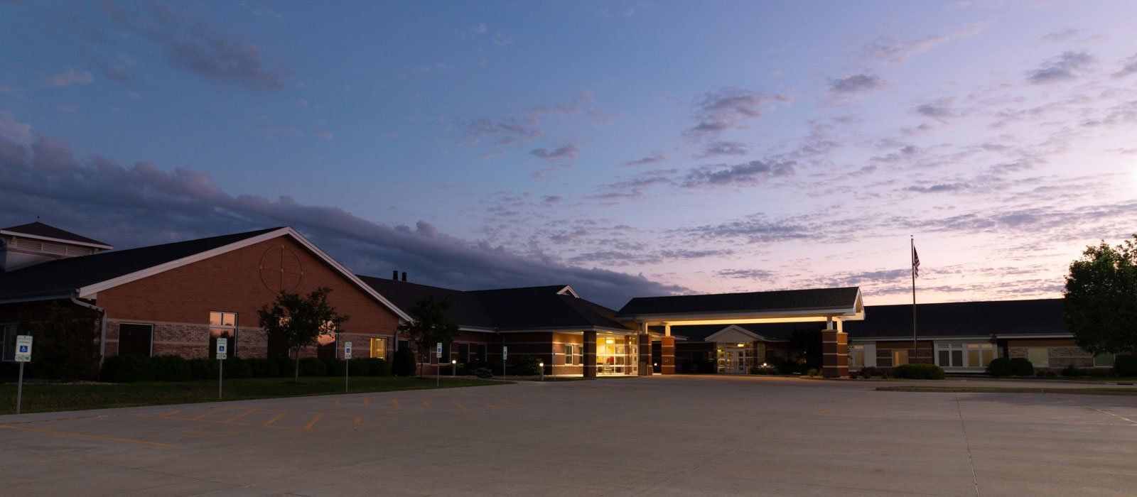 A large building with a lot of windows is lit up at night.