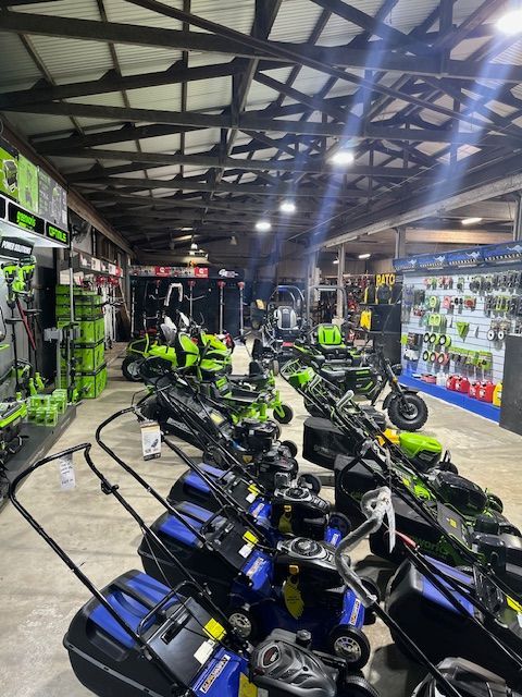 Green and Blue Lawn Mowers on Shop Floor — Mower Shop In Murwillumbah, NSW