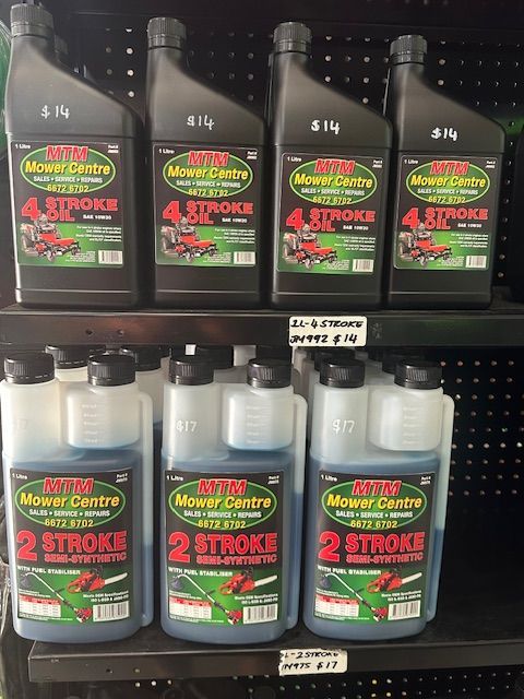 4 Stroke Oil & 2 Stroke Oil displayed on black shelf — Mower Shop In Murwillumbah, NSW