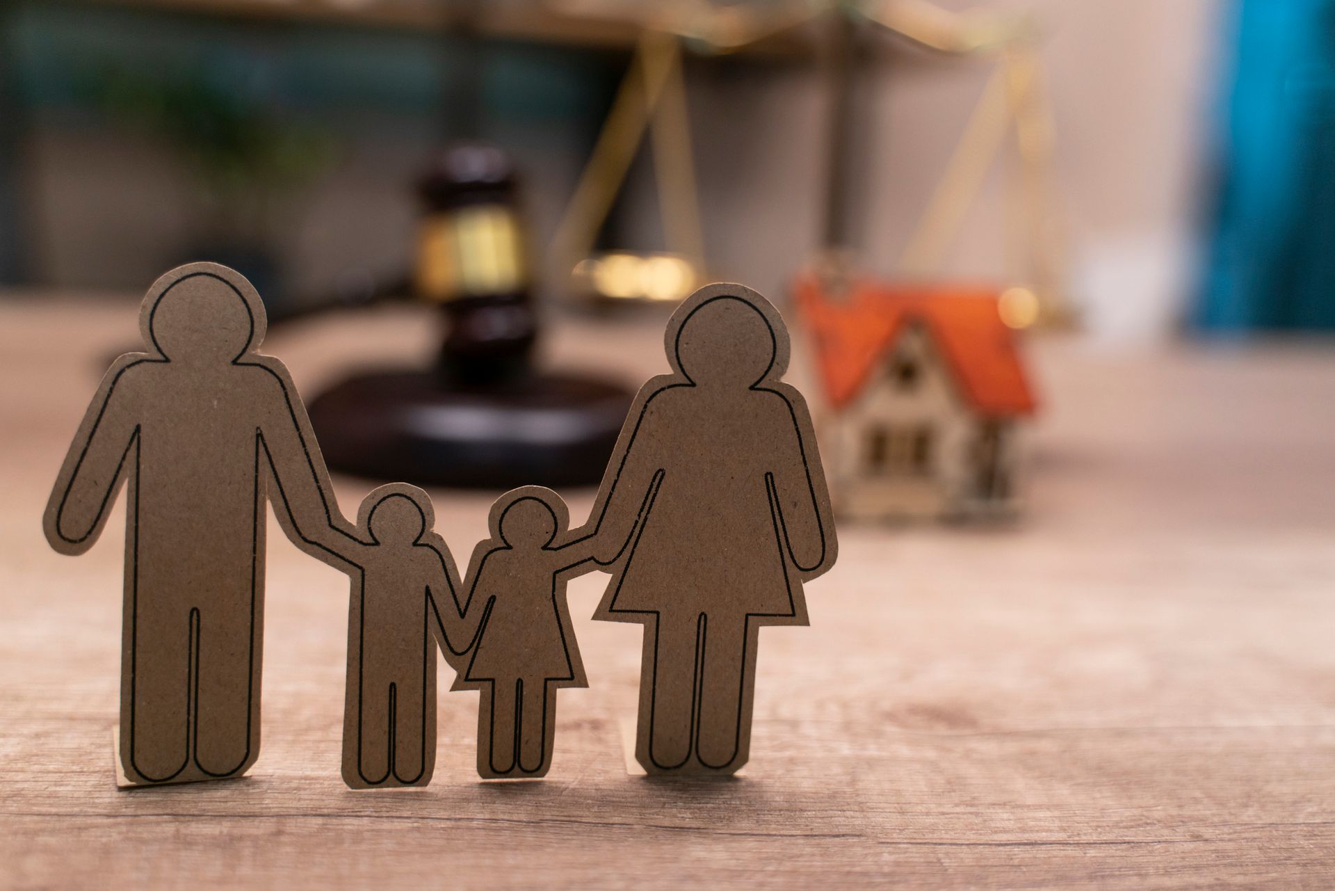 A man and woman are holding a little girl in their arms.