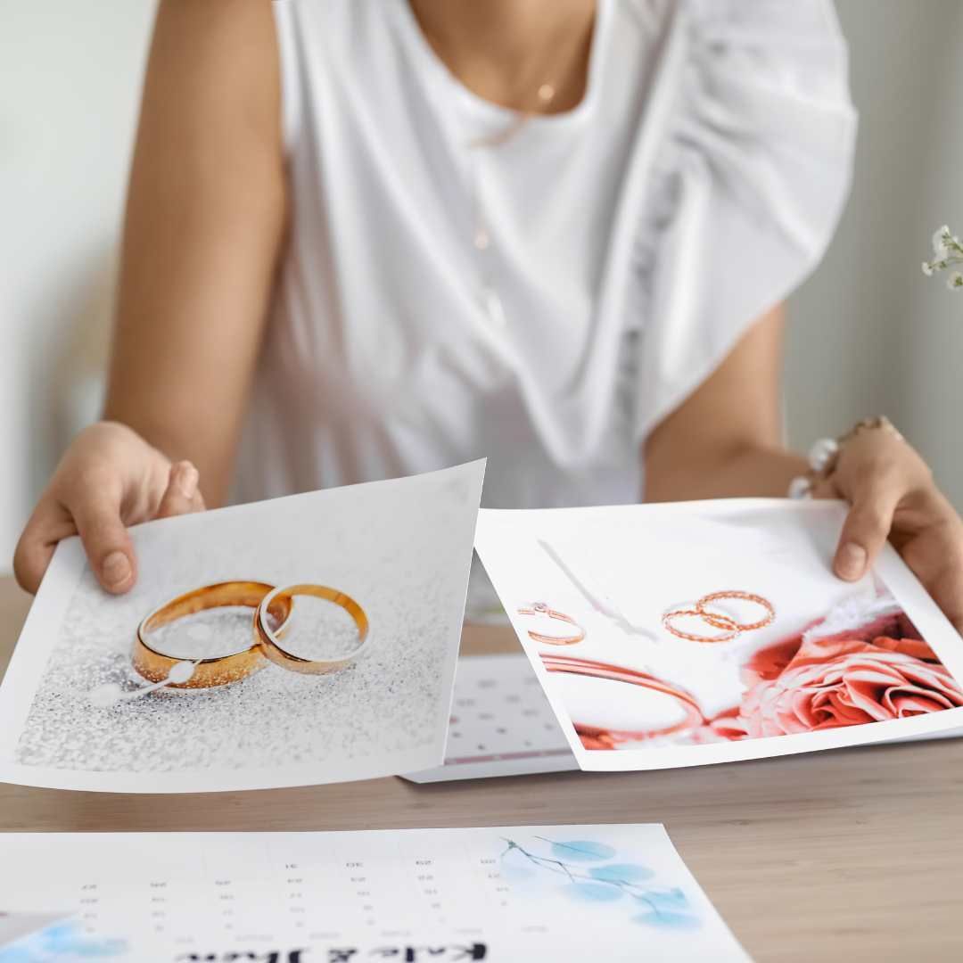 Woman holding photos of wedding rings.