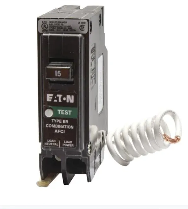 Eaton 15-amp circuit breaker with a coiled wire spring beside it on a white background