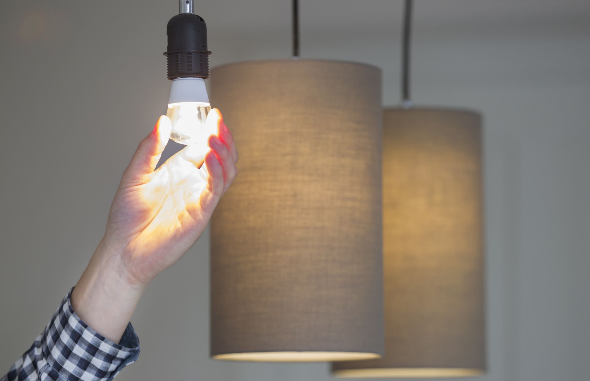 Residential light fixture being checked while troubleshooting flickering lights.