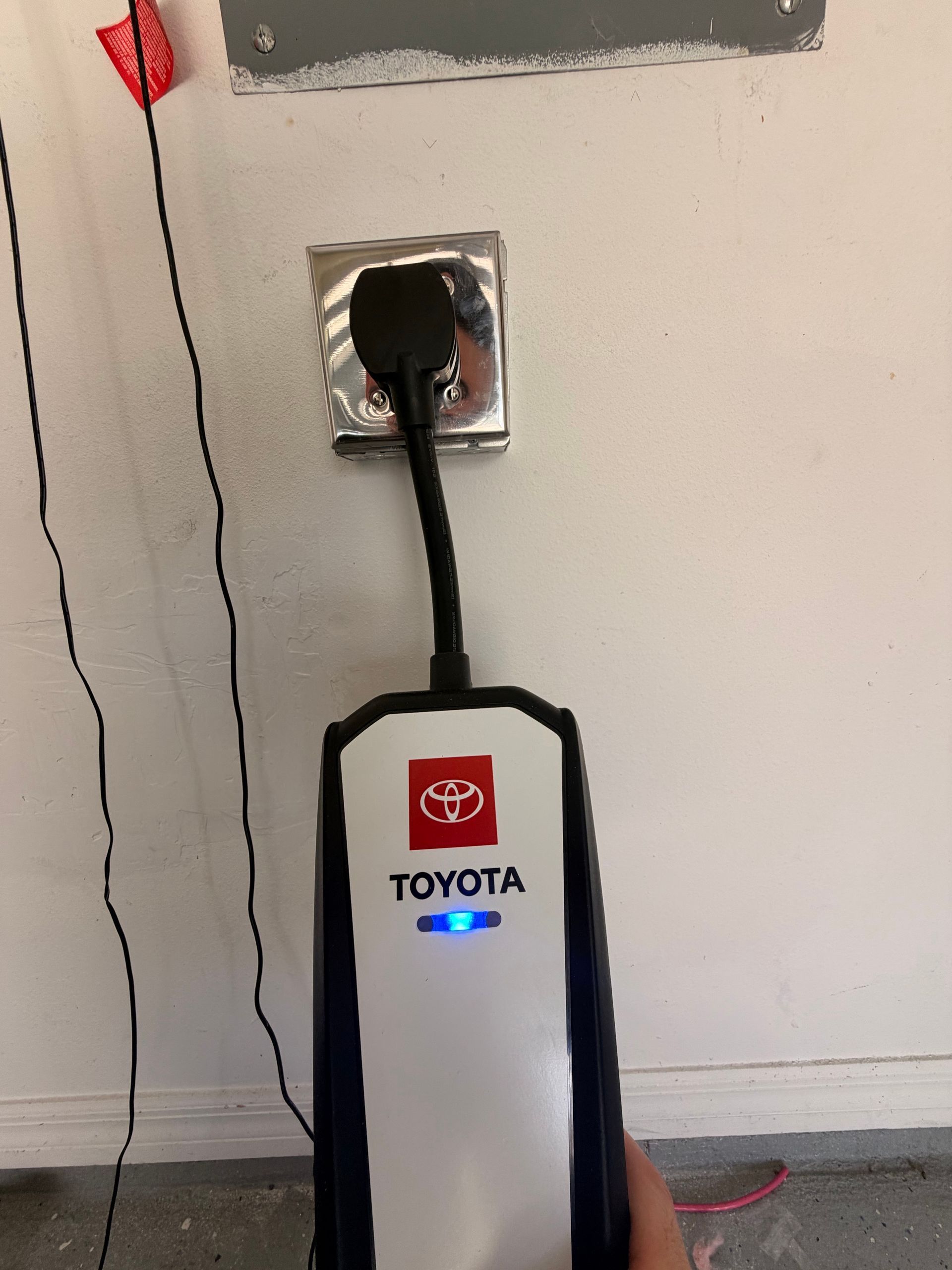 Portable EV charger plugged into the newly installed garage outlet.