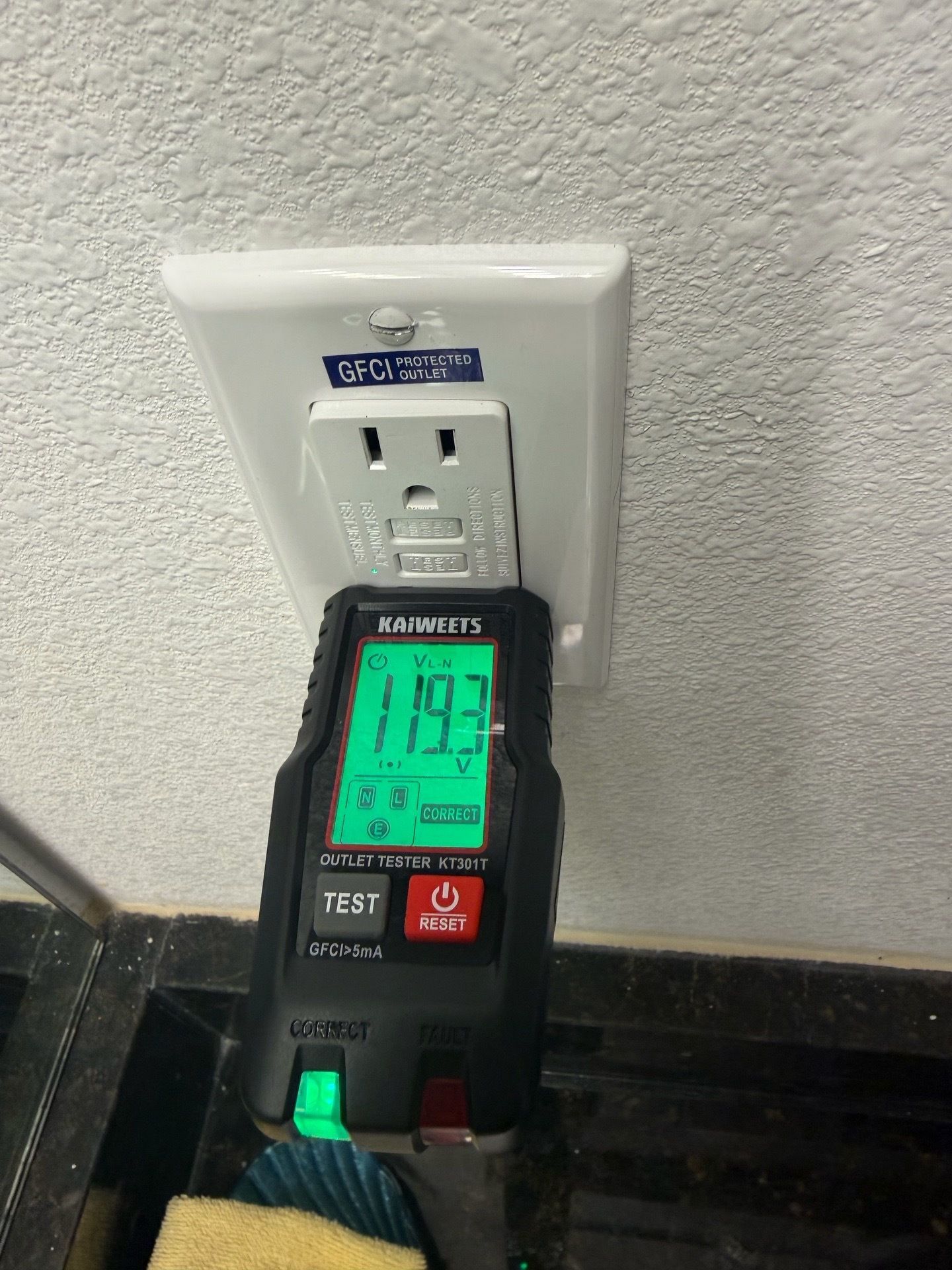 Electrical testing at a GFCI outlet.