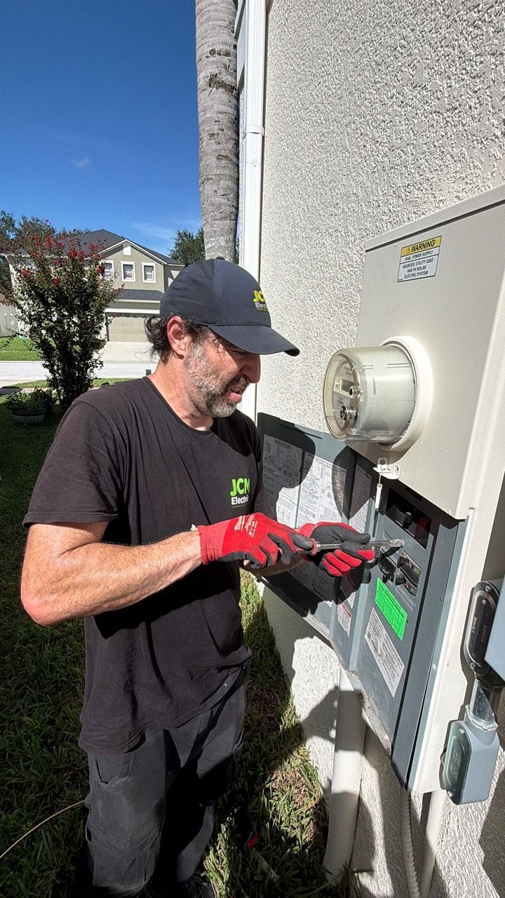 JCM Electric technician working at the home's outdoor electrical service equipment.