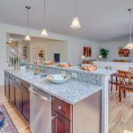 A kitchen with stainless steel appliances and granite counter tops.
