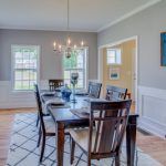 A dining room with a table and chairs and a chandelier.